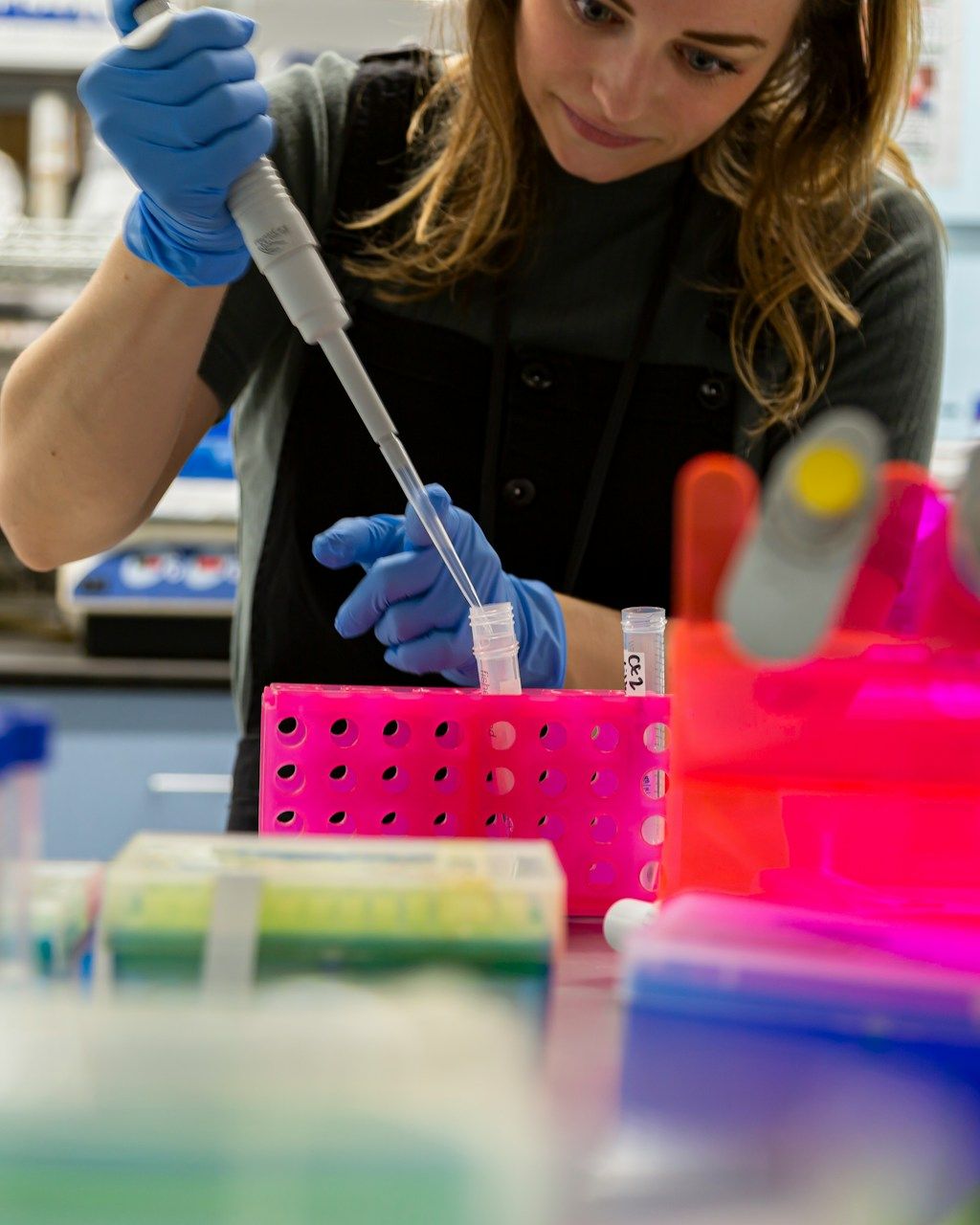 A chemist transferring a sample with a micropipette